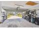 Open garage featuring storage shelves and outside view at 9942 56Th Way, Pinellas Park, FL 33782