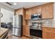 Kitchen featuring stainless steel appliances, natural wood cabinets, and granite countertops at 9942 56Th Way, Pinellas Park, FL 33782