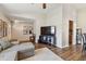 Well-lit living room featuring hardwood flooring, neutral walls, and an entertainment center at 9942 56Th Way, Pinellas Park, FL 33782