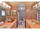 Retro bathroom with double vanity, shower, and patterned wallpaper at 1016 Teal Pointe, Tarpon Springs, FL 34689