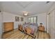 Bedroom with two twin beds, wood dresser, and ceiling fan at 1016 Teal Pointe, Tarpon Springs, FL 34689