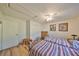 Bedroom with two twin beds, wood dresser, and ceiling fan at 1016 Teal Pointe, Tarpon Springs, FL 34689