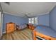 Bedroom with two twin beds and light blue walls at 1016 Teal Pointe, Tarpon Springs, FL 34689