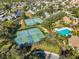 Aerial view of community amenities: tennis courts, pickleball courts, and a refreshing pool at 1016 Teal Pointe, Tarpon Springs, FL 34689