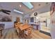 Dining area features a wood table with chairs, skylights, and a view of the kitchen at 1016 Teal Pointe, Tarpon Springs, FL 34689