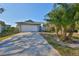 House exterior featuring a driveway and palm trees at 1016 Teal Pointe, Tarpon Springs, FL 34689