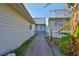 Pathway leading to house entrance with tropical plants at 1016 Teal Pointe, Tarpon Springs, FL 34689