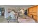 Living room with hardwood floors, leather furniture, and a view into the dining area at 1016 Teal Pointe, Tarpon Springs, FL 34689