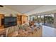 Bright living room features hardwood floors, leather furniture and sliding glass doors leading to a deck at 1016 Teal Pointe, Tarpon Springs, FL 34689