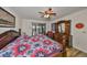 Large main bedroom with wood furniture and ceiling fan at 1016 Teal Pointe, Tarpon Springs, FL 34689