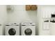 Laundry room with Samsung washer and dryer, and ample shelving at 10199 Gentle Rain Dr, Land O Lakes, FL 34638