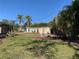 Large backyard with grassy area and detached building at 11217 Riverview Dr, Riverview, FL 33569