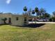 Detached carport with a covered area and grassy yard at 11217 Riverview Dr, Riverview, FL 33569