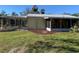 House exterior showcasing a screened porch and landscaping at 11217 Riverview Dr, Riverview, FL 33569