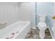 Clean bathroom featuring a white toilet and bathtub at 12080 Capri S Cir # 102, Treasure Island, FL 33706