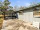 Rear view of the home featuring a concrete patio and access to a screened-in enclosure at 13050 110Th Ave, Largo, FL 33774