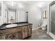 Bathroom featuring a wood vanity cabinet with a mirror, toilet, and walk-in shower at 13050 110Th Ave, Largo, FL 33774