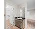 Bathroom featuring a vanity with a rustic wood cabinet and a walk-in closet at 13050 110Th Ave, Largo, FL 33774