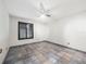 Bedroom featuring tiled flooring, a ceiling fan, and a window with dark shutters at 13050 110Th Ave, Largo, FL 33774