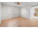 Bright bedroom with wood-look tile flooring and plantation shutters for lots of natural light at 13050 110Th Ave, Largo, FL 33774