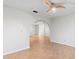 Bright bonus room with wood-look tile and archway, perfect for a den or office at 13050 110Th Ave, Largo, FL 33774