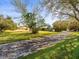 Long brick driveway leads up to this peaceful home with a lush green lawn at 13050 110Th Ave, Largo, FL 33774