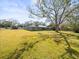 Expansive front yard with mature trees enhancing the curb appeal of this charming single-story home at 13050 110Th Ave, Largo, FL 33774