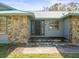 Inviting front entrance with stone accents and a modern metal roof for lasting curb appeal at 13050 110Th Ave, Largo, FL 33774