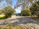 Features a grey garage with a matching metal roof and a patterned brick driveway at 13050 110Th Ave, Largo, FL 33774