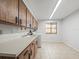 Laundry room featuring a sink, a washing machine, and wood cabinets for storage at 13050 110Th Ave, Largo, FL 33774