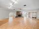 Open-concept living room with wood-look tile, fireplace, and arched doorways leading to other rooms at 13050 110Th Ave, Largo, FL 33774