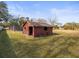 Exterior view of outdoor storage shed situated in a large grassy backyard at 13050 110Th Ave, Largo, FL 33774