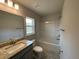 Bathroom with granite countertop, tub, and shower at 13146 Kent Bradley St, Dade City, FL 33525