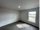 Well-lit bedroom featuring a large window and neutral wall colors at 13146 Kent Bradley St, Dade City, FL 33525