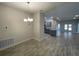 Bright dining area with chandelier and view of kitchen at 13146 Kent Bradley St, Dade City, FL 33525