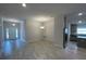 Open living area with grey tile floors and modern lighting at 13146 Kent Bradley St, Dade City, FL 33525