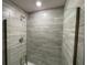 Clean shower with gray tile and glass enclosure at 13146 Kent Bradley St, Dade City, FL 33525