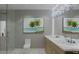 Modern bathroom with double vanity, stylish artwork, and tiled shower at 14046 Gulf Blvd # 2, Madeira Beach, FL 33708