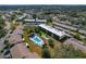 Aerial view of the community showcasing the condo buildings, pool, pond, and surrounding neighborhood at 1450 Heather Ridge Blvd # 305, Dunedin, FL 34698