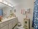 Bright bathroom with a large mirror, flamingo accents, and a charming vanity at 1450 Heather Ridge Blvd # 305, Dunedin, FL 34698