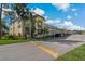 Well-maintained condo building featuring covered parking, manicured landscaping, and inviting outdoor spaces at 1450 Heather Ridge Blvd # 305, Dunedin, FL 34698