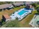 Aerial view of the community pool with surrounding patio and lush greenery, creating a resort-like atmosphere at 1450 Heather Ridge Blvd # 305, Dunedin, FL 34698