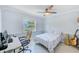 Bedroom with a bed, desk, and guitar at 1505 Mission Hills Blvd # 4D, Clearwater, FL 33759