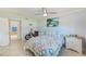 Bright bedroom with queen bed, dresser, and access to bathroom at 1505 Mission Hills Blvd # 4D, Clearwater, FL 33759