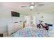 Bedroom with queen bed, dresser, and access to laundry and bathroom at 1505 Mission Hills Blvd # 4D, Clearwater, FL 33759