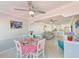 Open dining area with white table and chairs, views to living room at 1505 Mission Hills Blvd # 4D, Clearwater, FL 33759