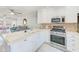 Open concept kitchen with island and stainless appliances at 1505 Mission Hills Blvd # 4D, Clearwater, FL 33759