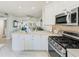 Open kitchen boasts stainless steel appliances and white cabinets at 1505 Mission Hills Blvd # 4D, Clearwater, FL 33759