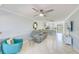 Living room features gray couch, and open concept to kitchen and dining areas at 1505 Mission Hills Blvd # 4D, Clearwater, FL 33759