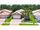 Single-Gathering home with a two-car garage and nicely landscaped yard at 16028 Golden Lakes Dr, Wimauma, FL 33598